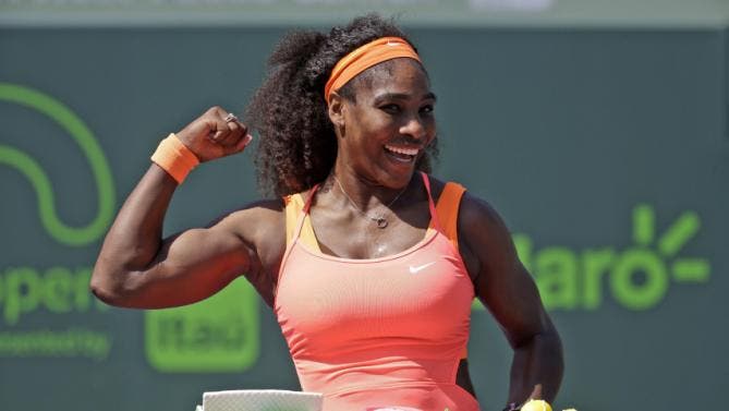 Serena Williams poses with cake celebrating her 400th career win after she defeated Sabine Lisicki during their quarterfinal match at the Miami Open tennis tournament, Wednesday, April 1, 2015, in Key Biscayne, Fla. Williams won the match 7-6 (4), 1-6, 6-3. (AP Photo/Lynne Sladky)