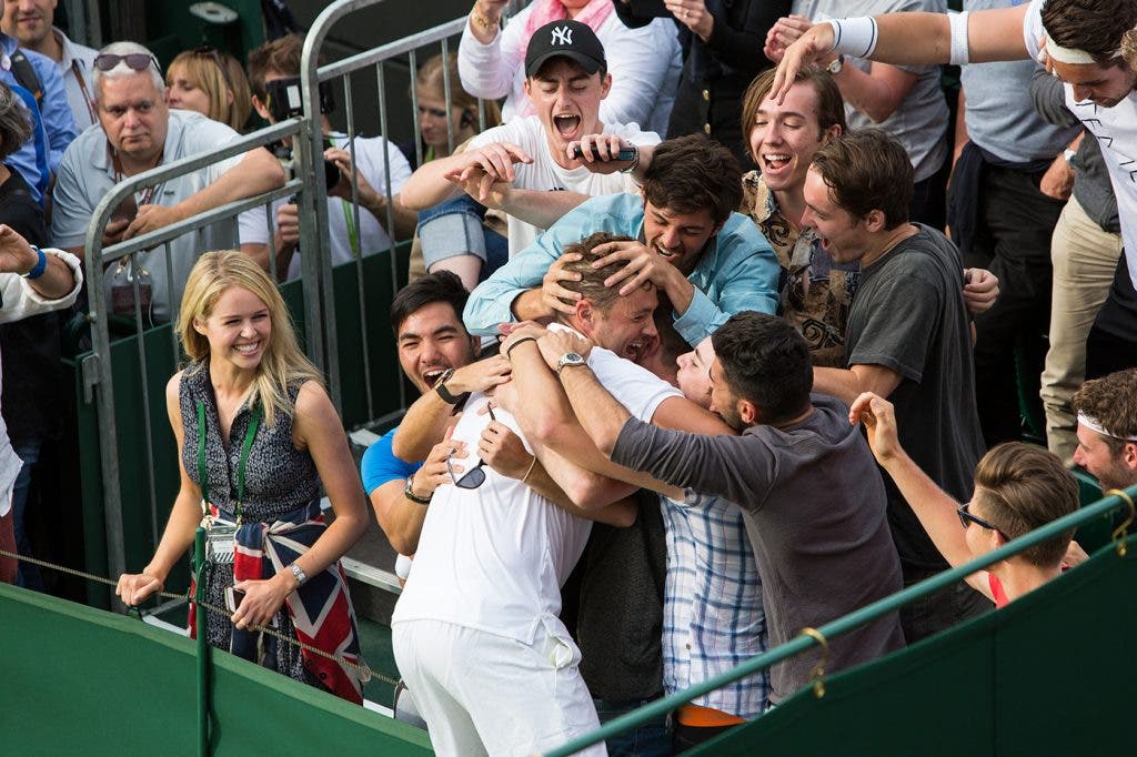 AELTC/David Levenson . 27 June 2016 Marcus Willis GBR dives into the crowd, including his girlfriend and friends, to celebrate his win over Ricardas Berankis (LTU). The Championships 2016 at The All England Lawn Tennis Club, Wimbledon. Day 1 Monday 27/06/2016. AELTC/David Levenson