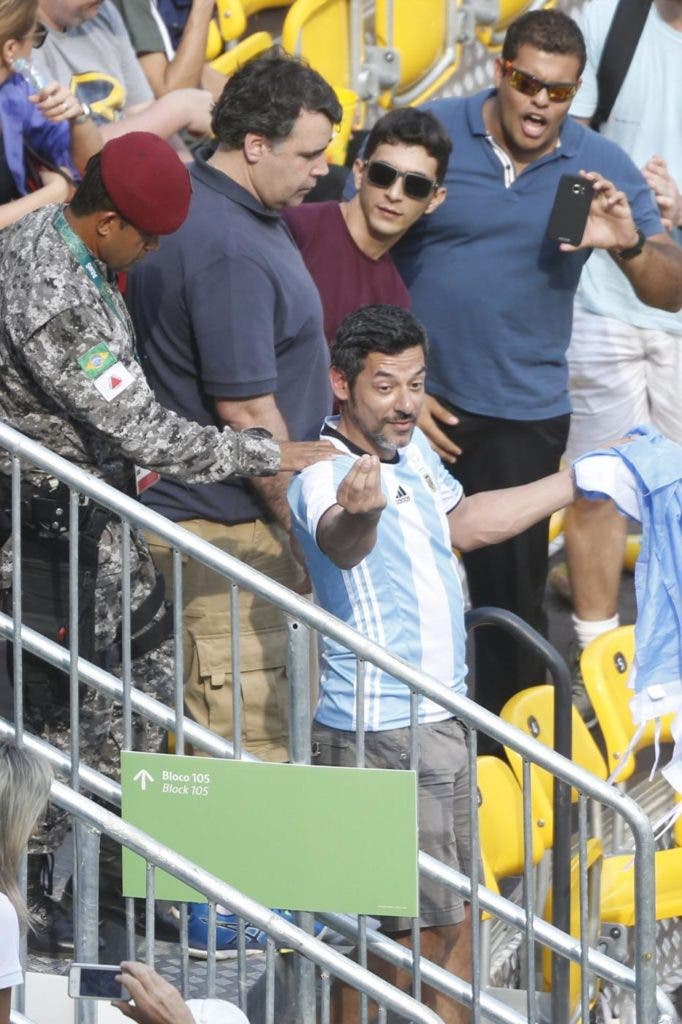epa05465272 An Argentinian fan is escorted by security personnel after a scuffle with another fan during men's singles match between Juan Martin Del Potro of Argentina and Joao Sousa of Portugal of the Rio 2016 Olympic Games Tennis events at the Olympic Tennis Centre in the Olympic Park in Rio de Janeiro, Brazil, 08 August 2016. EPA/MICHAEL REYNOLDS / Olympic Games 2016 Tennis / EPA / MICHAEL REYNOLDS / epa05465272 / BRAZIL RIO 2016 OLYMPIC GAMES / TENNIS / olympic; olympics; olympic games; rio olympic games; rio de janeiro; rio 2016; rio2016; summer olympics; summer olympic games; summer games; brazil; rio 2016 olympic games; rio summer olympics / RIO DE JANEIRO