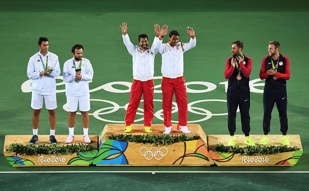 Gold medallists Spain's Marc Lopez (3rd L) and Spain's Rafael Nadal (3rd R), silver medallist Romania's Florin Mergea (2nd R) and Romania's Horia Tecau (L) and bronze medallists US players Steve Johnson (2nd L) and Jack Sock celebrate on the podium of the men's doubles final tennis match at the Olympic Tennis Centre of the Rio 2016 Olympic Games in Rio de Janeiro on August 12, 2016. / AFP / Martin BERNETTI (Photo credit should read MARTIN BERNETTI/AFP/Getty Images)